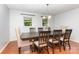 Cozy dining room featuring a dark wood table, upholstered chairs, chandelier, and natural light from the windows at 3049 Stablegate Dr, Gastonia, NC 28052