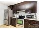 The kitchen features stainless steel appliances, granite countertops, and dark wood cabinetry at 3049 Stablegate Dr, Gastonia, NC 28052