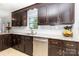 Stylish kitchen features dark wood cabinets, granite countertops, subway tile backsplash, and modern appliances at 3049 Stablegate Dr, Gastonia, NC 28052