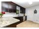 Well-maintained kitchen with dark wood cabinets, granite countertops, and modern appliances at 3049 Stablegate Dr, Gastonia, NC 28052