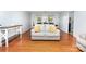 Bright living room featuring hardwood floors, a comfortable sofa, and an open layout to the dining area at 3049 Stablegate Dr, Gastonia, NC 28052