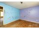 A bedroom with defaced walls and hardwood flooring at 3316 Fairhaven Rd, Rock Hill, SC 29732