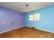 A bedroom with hardwood floors and colorfully defaced walls at 3316 Fairhaven Rd, Rock Hill, SC 29732