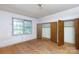 Bedroom highlighting natural light from a window and closet space with flooring ready for renovation and customization at 3316 Fairhaven Rd, Rock Hill, SC 29732