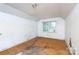 Bedroom featuring a window and plywood floors, showcasing a simple and functional space ready for renovation at 3316 Fairhaven Rd, Rock Hill, SC 29732