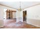 Empty dining room featuring vintage-style wallpaper, hardwood floors, and a brass chandelier at 3316 Fairhaven Rd, Rock Hill, SC 29732