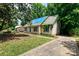 Charming home with a blue tarp on the roof and mature trees, offering a picturesque setting at 3316 Fairhaven Rd, Rock Hill, SC 29732