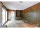 Living room featuring a brick fireplace, built-in shelves, French doors, and wood paneling at 3316 Fairhaven Rd, Rock Hill, SC 29732