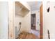 Utility room with outdated fixtures and hardwood floors, leading into a bathroom at 3316 Fairhaven Rd, Rock Hill, SC 29732
