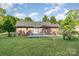 Brick house features a spacious backyard with a grey deck at 3555 Tree Line Dr, Rock Hill, SC 29732