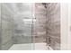 Modern bathroom features stylish gray tile, glass shower door, and sleek fixtures for a luxurious feel at 3555 Tree Line Dr, Rock Hill, SC 29732