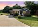 Charming brick home with blue siding accents, landscaped yard, and a concrete driveway at sunset at 3555 Tree Line Dr, Rock Hill, SC 29732