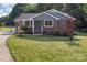 Well-maintained home featuring brick facade, blue siding, manicured lawn, and lush shrubbery at 3555 Tree Line Dr, Rock Hill, SC 29732