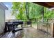 Wet wooden deck with a grill and green foliage in the background at 403 Carpenter Parker Ln, Rock Hill, SC 29730