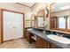 Bathroom with a vanity featuring double sinks and decorative light fixtures and mirrors at 403 Carpenter Parker Ln, Rock Hill, SC 29730