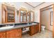 Bright bathroom with a vanity featuring double sinks and decorative light fixtures at 403 Carpenter Parker Ln, Rock Hill, SC 29730