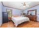 Spacious bedroom with hardwood floors, a large bed, ample natural light, and traditional dresser at 403 Carpenter Parker Ln, Rock Hill, SC 29730