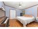 Relaxing bedroom with hardwood floors, a cozy bed, ample natural light, and traditional piano at 403 Carpenter Parker Ln, Rock Hill, SC 29730