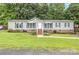Charming single-story home with well-maintained lawn, brick foundation and inviting front porch at 403 Carpenter Parker Ln, Rock Hill, SC 29730