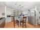 Well-lit kitchen featuring white cabinets, stainless steel appliances, tile countertops, and hardwood floors at 403 Carpenter Parker Ln, Rock Hill, SC 29730