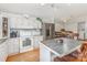 Bright kitchen with white cabinets, stainless steel appliances, an island with seating, and seamless flow to dining at 403 Carpenter Parker Ln, Rock Hill, SC 29730