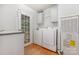 Bright laundry room with sink, washer, dryer, storage, and direct access to the exterior at 403 Carpenter Parker Ln, Rock Hill, SC 29730