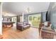 Inviting living room with a leather sofa, pool table, hardwood floors, and natural light from large windows at 403 Carpenter Parker Ln, Rock Hill, SC 29730