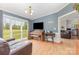 Comfortable living room with natural light, hardwood floors, piano, and access to the kitchen at 403 Carpenter Parker Ln, Rock Hill, SC 29730