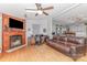 Cozy living room with hardwood floors, a fireplace, and an open layout leading to the kitchen at 403 Carpenter Parker Ln, Rock Hill, SC 29730