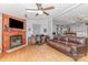 Cozy living room with hardwood floors, a fireplace, and an open layout leading to the kitchen at 403 Carpenter Parker Ln, Rock Hill, SC 29730