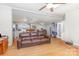 Open living space with hardwood floors, a comfortable leather sofa, and seamless flow to kitchen and office at 403 Carpenter Parker Ln, Rock Hill, SC 29730