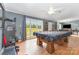 View of the living room with an American flag themed pool table, hardwood floors and natural light at 403 Carpenter Parker Ln, Rock Hill, SC 29730