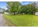 Expansive grassy yard featuring mature trees and foliage, as well as a storage shed at 403 Carpenter Parker Ln, Rock Hill, SC 29730