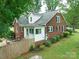 Charming brick home featuring a fenced yard, mature trees, and a cozy sunroom at 4098 S Nc Hwy 127 Hwy, Hickory, NC 28602