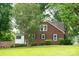 Rear view of a brick house with well-kept lawn, shaded by mature trees and offering privacy at 4098 S Nc Hwy 127 Hwy, Hickory, NC 28602
