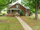 Charming brick home with black shutters, a well-maintained lawn, and mature trees at 4098 S Nc Hwy 127 Hwy, Hickory, NC 28602