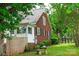 Side view of a charming brick home with white trim, a fenced yard, and beautiful landscaping at 4098 S Nc Hwy 127 Hwy, Hickory, NC 28602