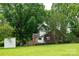 A quaint brick home nestled on a lush, green lawn with mature trees providing ample shade at 4098 S Nc Hwy 127 Hwy, Hickory, NC 28602