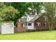 Charming brick home featuring a well-manicured lawn, mature trees, and a backyard shed at 4098 S Nc Hwy 127 Hwy, Hickory, NC 28602