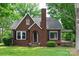 Cozy brick home with black shutters, arched door, chimney, and large lawn at 4098 S Nc Hwy 127 Hwy, Hickory, NC 28602