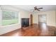 Inviting living room featuring hardwood floors, fireplace, and large window overlooking yard at 4098 S Nc Hwy 127 Hwy, Hickory, NC 28602