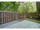A backyard features a grey stone area, fenced-in patio, and mulched planting beds at 411 Steel Gardens Blvd, Charlotte, NC 28205