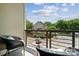 A serene balcony with comfortable seating, a table, and pleasant neighborhood views at 411 Steel Gardens Blvd, Charlotte, NC 28205