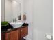 Bathroom with a decorative sink, wood cabinets and a granite countertop at 411 Steel Gardens Blvd, Charlotte, NC 28205