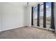 Bright bedroom with plush carpeting, high ceilings, and large windows with streaming sunlight at 411 Steel Gardens Blvd, Charlotte, NC 28205