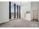 Bright bedroom with plush carpeting, high ceilings, and large windows with streaming sunlight at 411 Steel Gardens Blvd, Charlotte, NC 28205