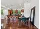 Open concept dining area featuring a round table with green chairs and modern kitchen and bar at 411 Steel Gardens Blvd, Charlotte, NC 28205