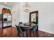 Cozy dining area featuring a round table, green chairs, modern light fixture, and stainless steel refrigerator at 411 Steel Gardens Blvd, Charlotte, NC 28205