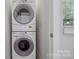 This laundry room has a stacked washer and dryer with a window to let in natural light at 411 Steel Gardens Blvd, Charlotte, NC 28205