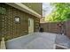 This backyard patio has a stone area and a fenced-in space with brick exterior walls at 411 Steel Gardens Blvd, Charlotte, NC 28205